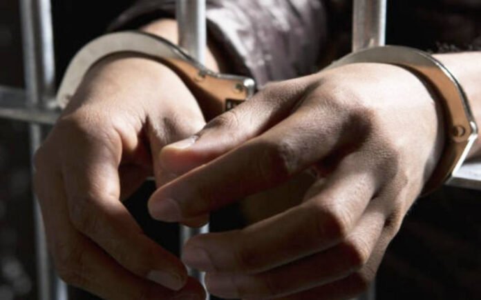 Arrested suspect in handcuffs.