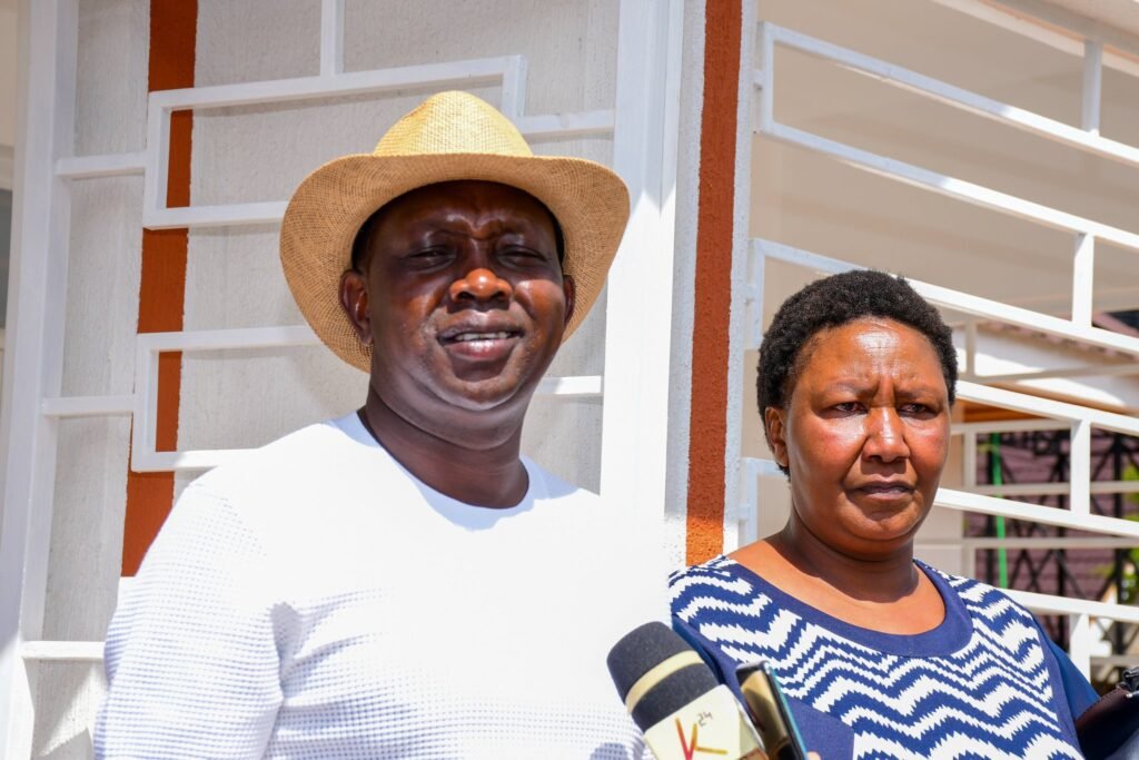 Peninah Manyara (Mama Mungai) stands with Kapseret MP Oscar Sudi at her new three-bedroom home in Lemook, Kapseret, built ten months after she lost her son.