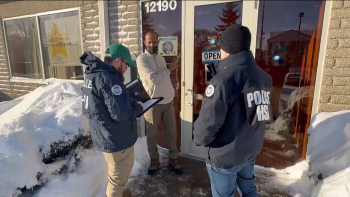 Two DHS officers question a man during a door-to-door fraud investigation in Minneapolis, part of a federal probe including sites linked to Somali immigrant communities. Two DHS officers question a man during a door-to-door fraud investigation in Minneapolis, part of a federal probe including sites linked to Somali immigrant communities.