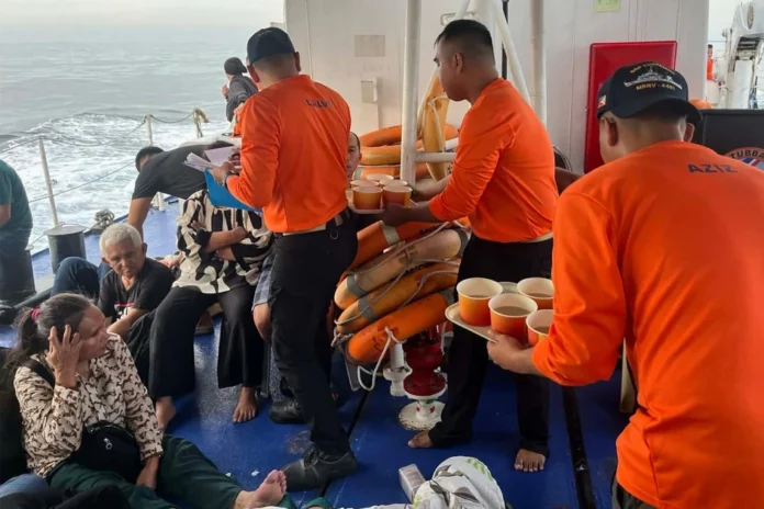AFP__20260126__93YE3EB__v2__HighRes__TopshotPhilippinesTransportAccident-og_image This handout photo from the Philippine Coast Guard (PCG) taken and received on January 26, 2026 shows coast guard crew attending to the survivors of the sunken M/V Trisha Kerstin 3 in waters off Basilan province.