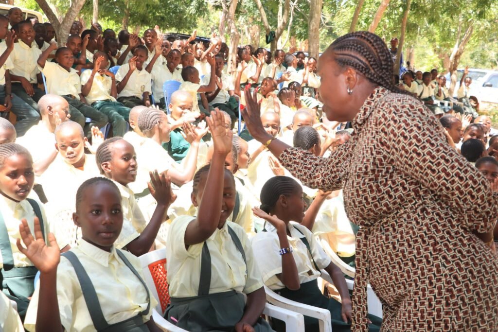 Pamela Njoki Njeru greets students during the launch of the Embu County Sanitary Pads Programme at Urban Primary School in Embu West Sub-County.