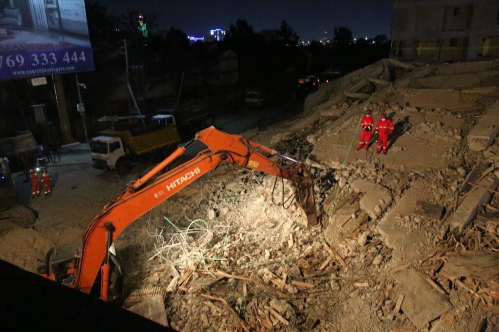 Emergency responders conduct search and rescue operations at the site of a collapsed multi-storey building in South C, Nairobi, as authorities cordon off the area and assess nearby structures for safety.