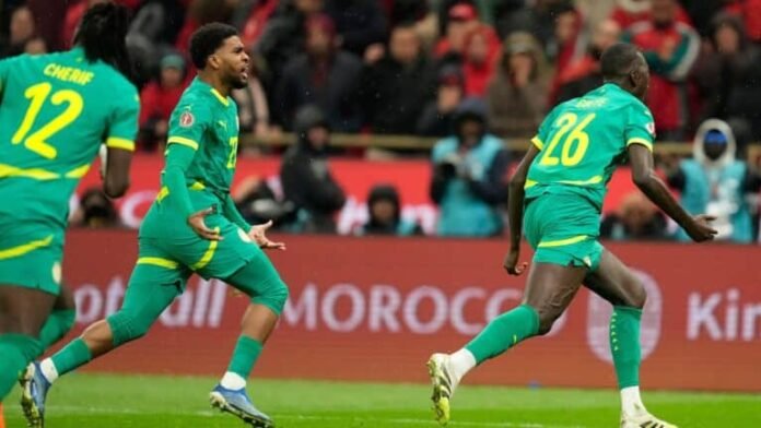IMG_5181 Senegal players celebrate after the final whistle, embracing and waving their national flag as they are crowned Africa Cup of Nations champions following a dramatic victory over Morocco.