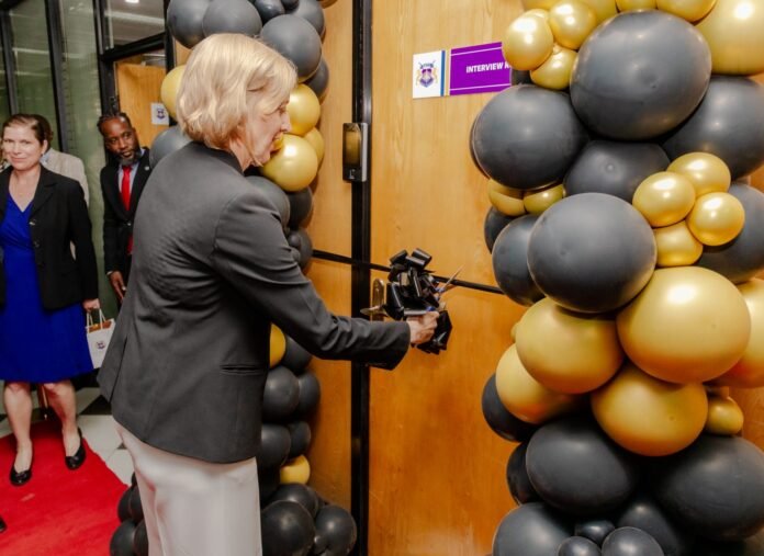 EACC US Embassy Chargé d’Affaires Susan Burns cuts the ribbon during the official launch of EACC’s modern interview facility, developed in partnership with the FBI and INL, to strengthen anti-corruption investigations in Kenya.