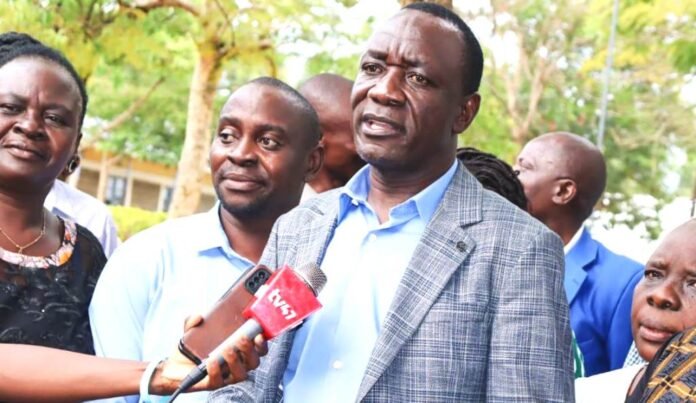 Kanduyi-MP-John-Makali-addresses-the-media-after-handing-over-cheques-to-school-heads.-Tony-Wafula