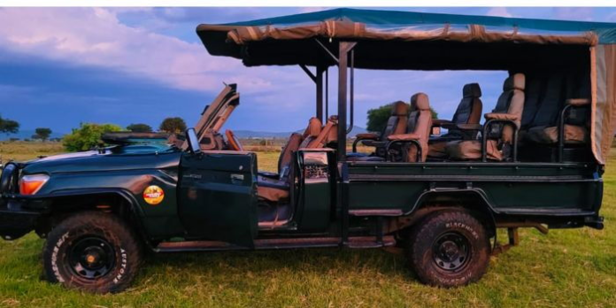 image Open sides land cruiser parked inside the Maasai Mara National Reserve.
