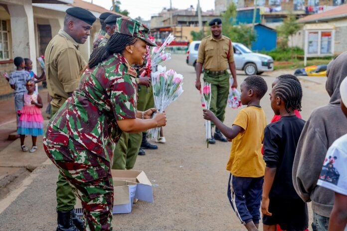 Dagoretti South police officers giving flowers and interacting with children on Valentine’s Day.
