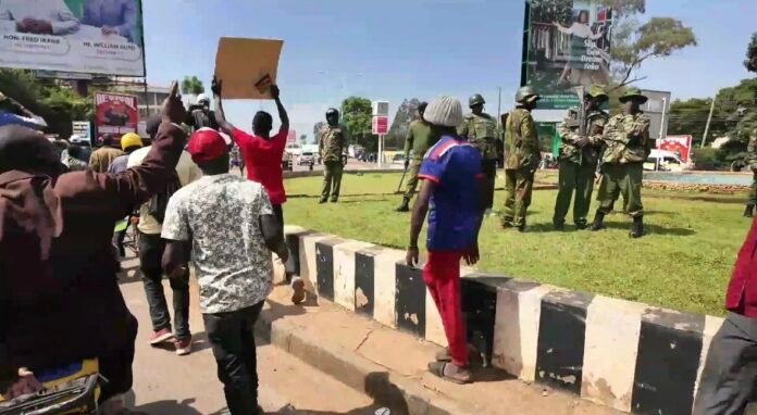 Kakamega A group of pro-Sifuna supporters pass a roundabout in Kakamega, closely monitored by anti-riot police officers ahead of the Linda Mwananchi rally.