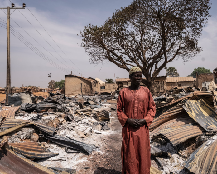 image A resident stands among burnt debris and damaged homes after the attack in Woro, Kwara state, on February 5, 2026.