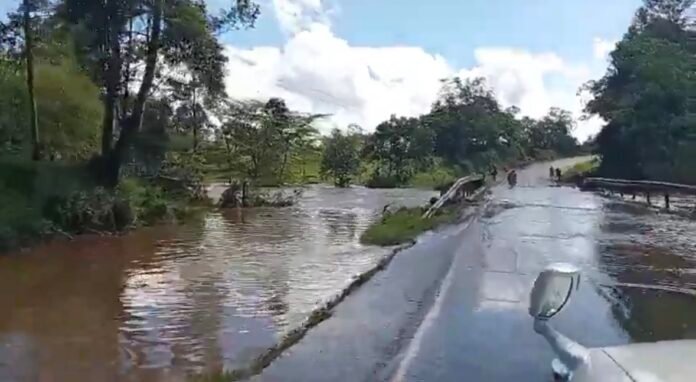 KeNHA Kenya National Highways Authority engineers and police officers monitor the flooded Kipsonoi River Bridge at Mugeni, advising motorists to use alternative routes for safety.