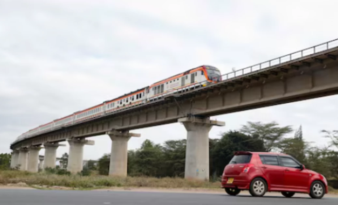 SGR A car passes under a bridge as a train moves along the Standard Gauge Railway (SGR) line constructed by China Road and Bridge Corporation (CRBC) and financed by the Chinese government in Athi River, Kenya, June 3, 2022.
