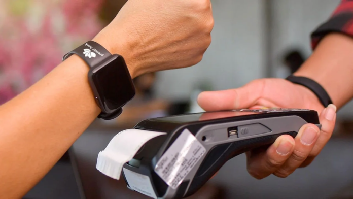 Kenyan banks adopt smartwatches, rings and wristbands for contactless payments, raising convenience and security questions in a cashless shift.