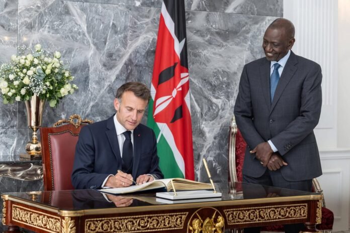 Ruto-Macron President William Ruto stands beside French President Emmanuel Macron as he signs the visitors’ book at State House, Nairobi, during an official visit marking strengthened Kenya–France relations.