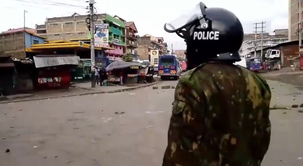 Police officers patrol a street in Kayole amid heightened security during the nationwide transport strike in Kenya.