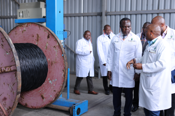 image Joseph Kamau, Production Manager at East African Cables (EAC), demonstrates the process of manufacturing aerial bundled conductors to Dr Juma Mukhwana, Principal Secretary for the State Department of Industry in the Ministry of Investments, Trade and Industry during a visit to the EAC’s Nairobi Industrial Area Factory on Thursday