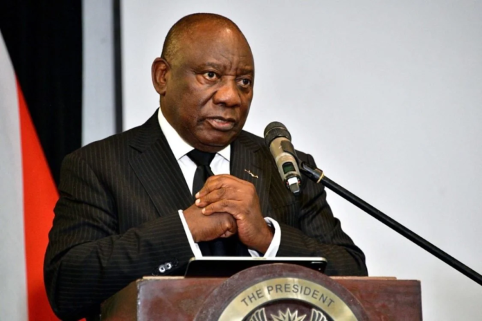 image Close-up portrait of South African President Cyril Ramaphosa wearing a dark suit and black tie, during a 2026 address.